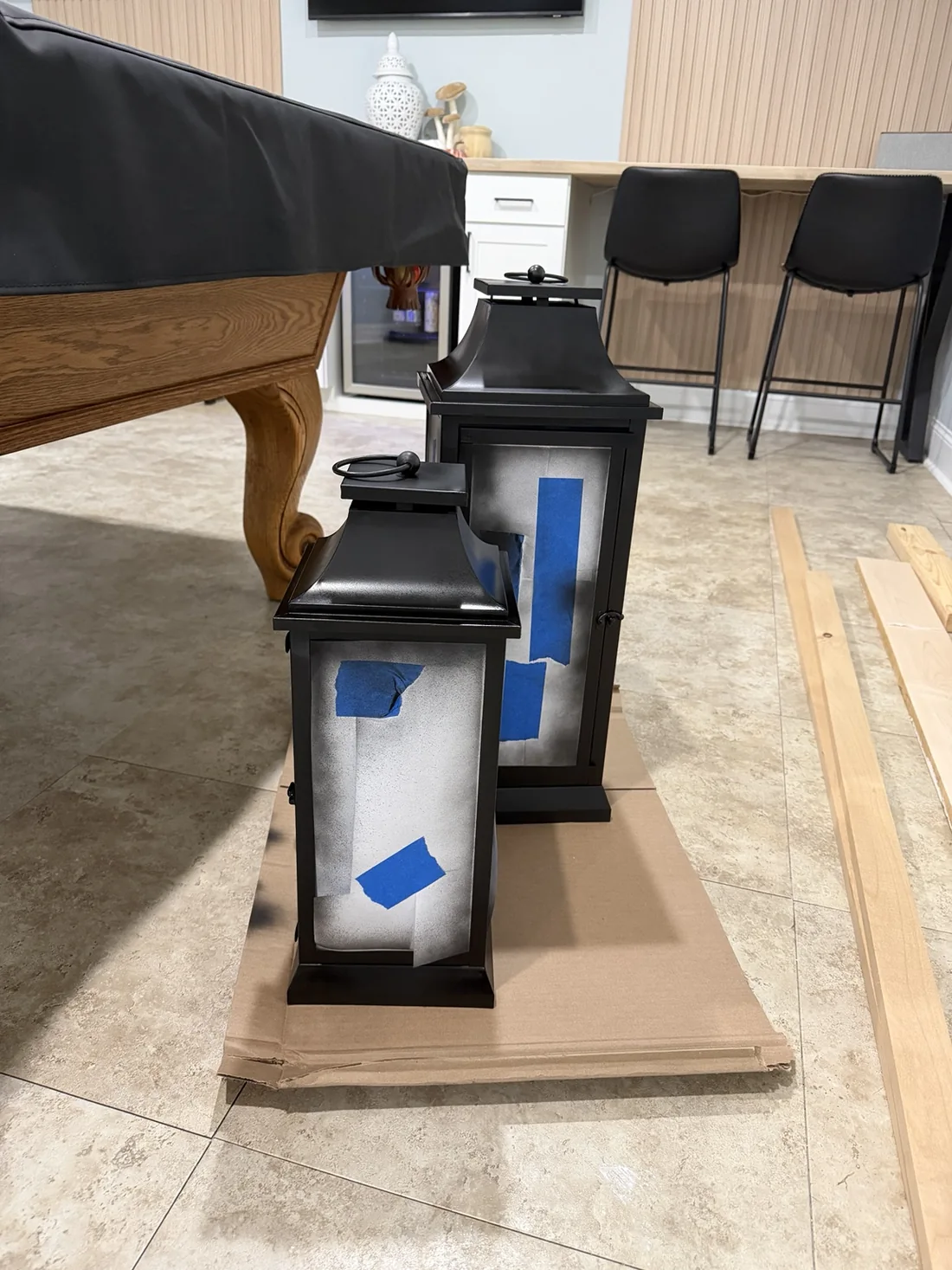 Two lanterns with their glass masked, standing on a movable board so they could be repositioned without touching the lantern frames
