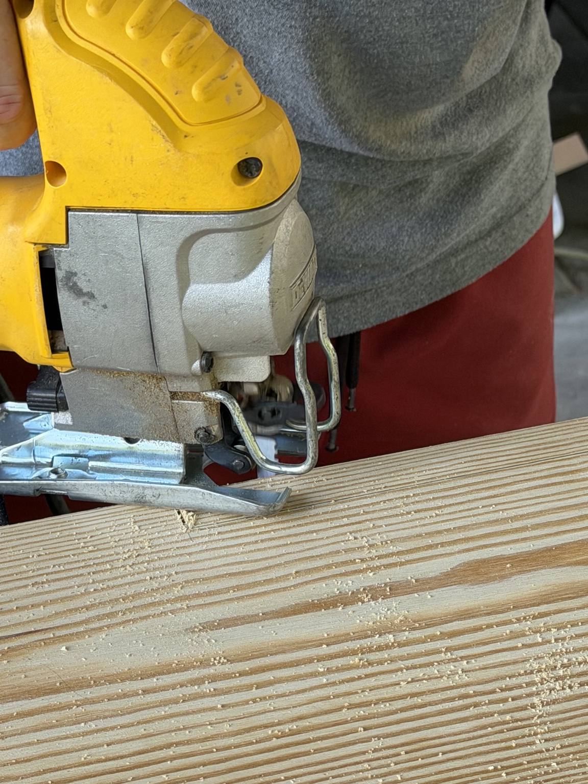 Jigsaw cutting a notch in the pine for the fireplace mantel