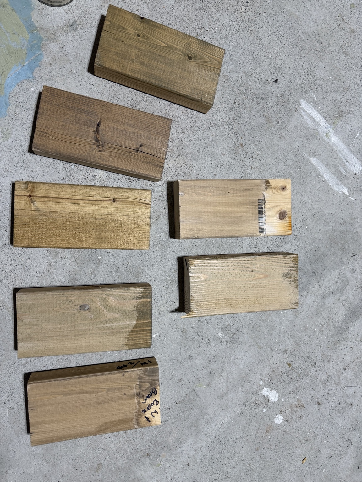 Small pieces of pine with stain finish samples for the mantel