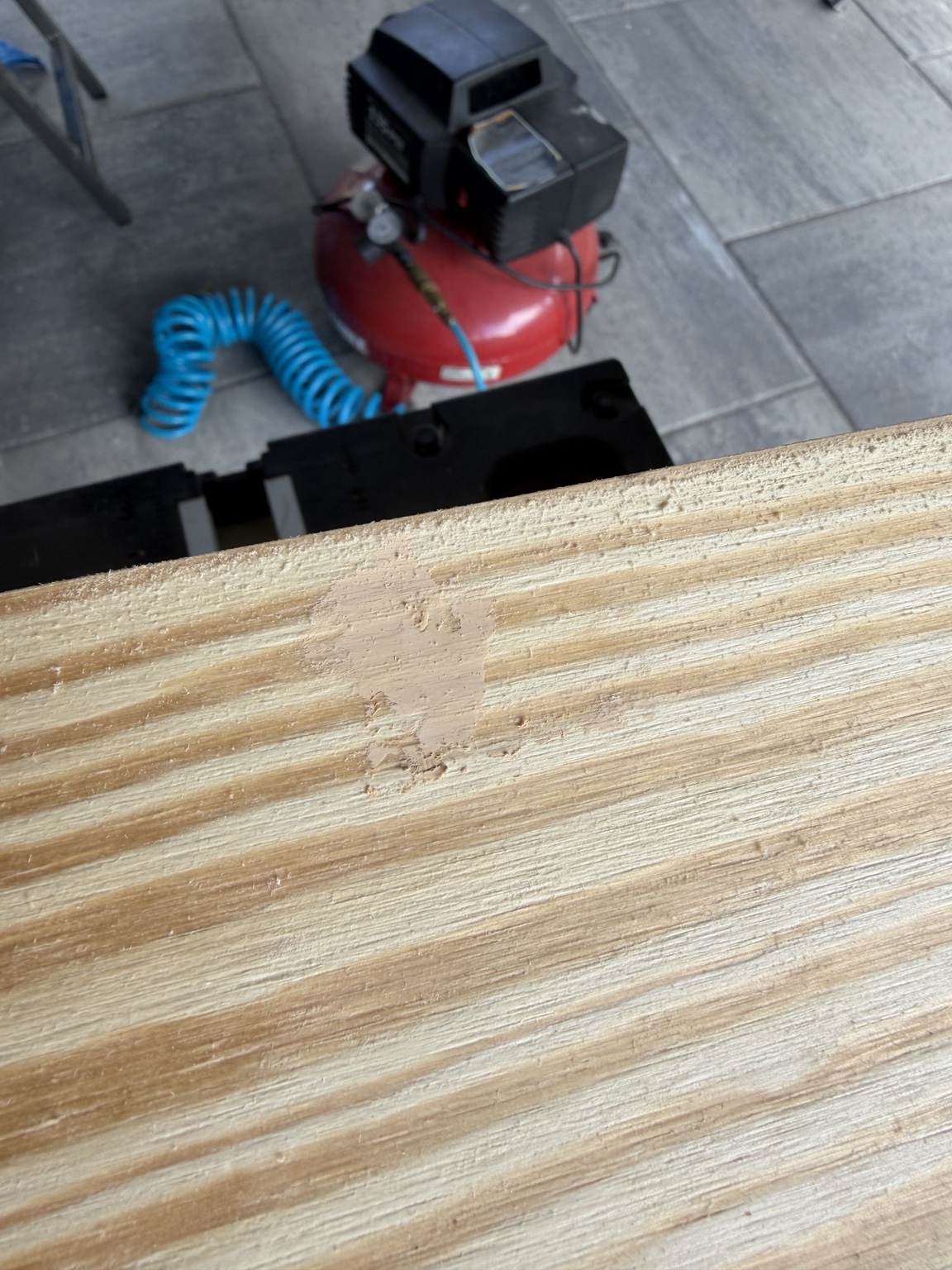 Orbital sander smoothing the pine mantel