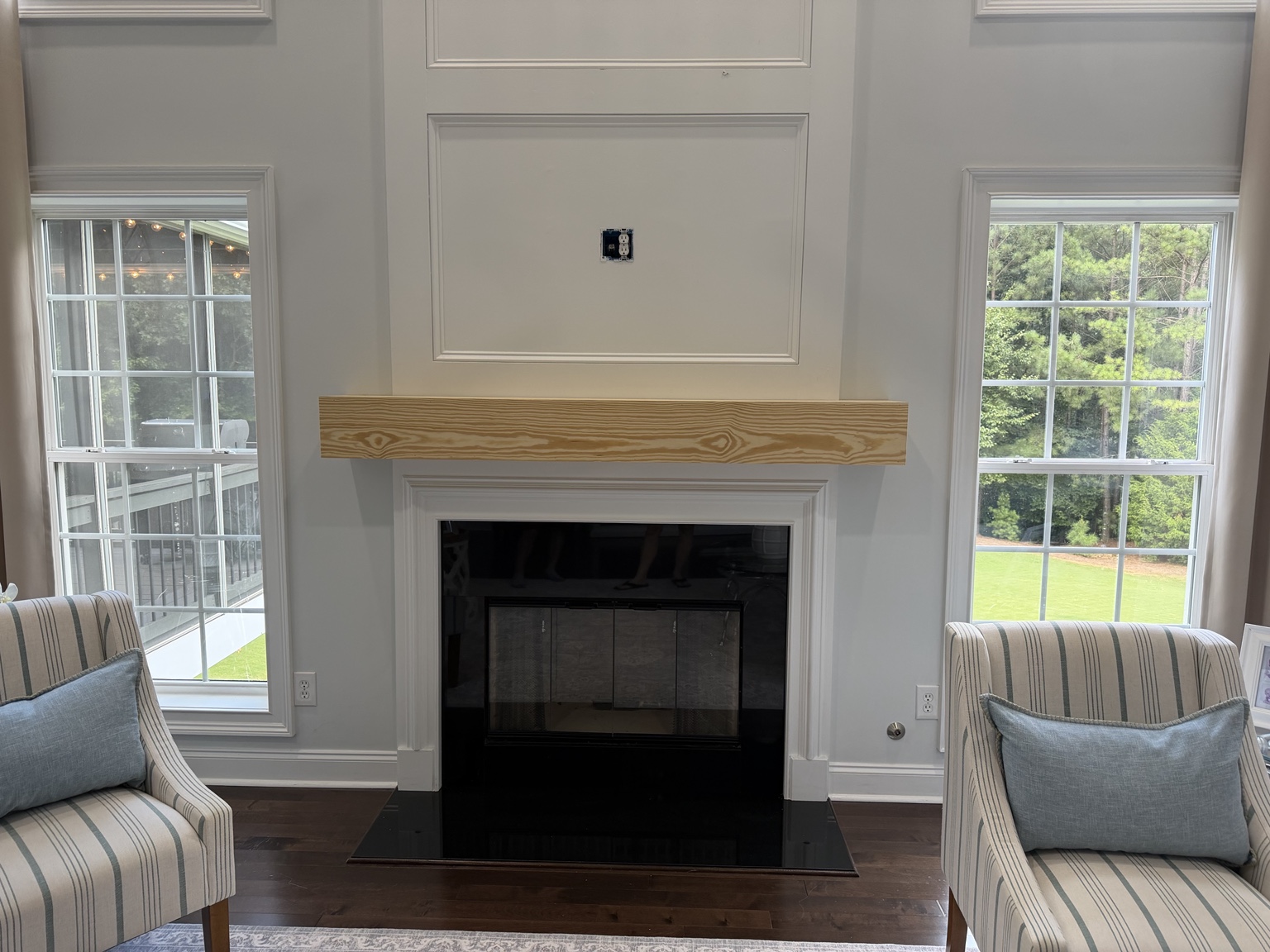 Raw pine box mantel dry-fitted over white fireplace