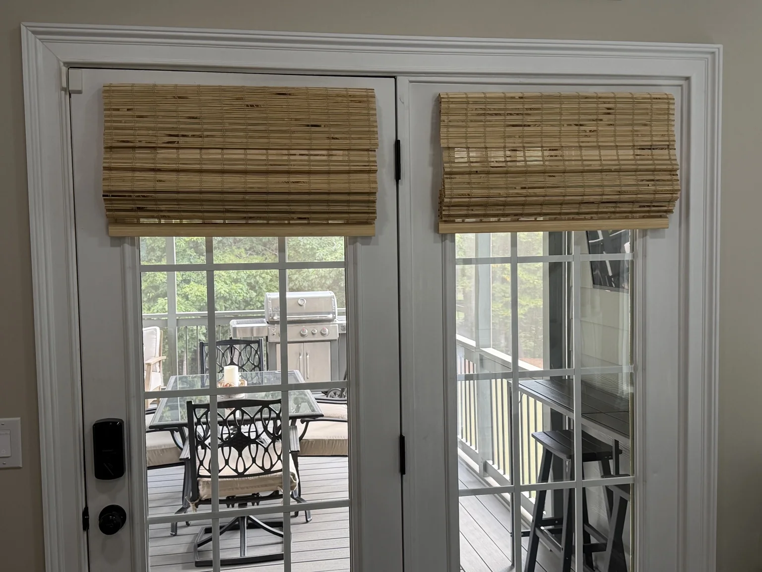 Two bamboo shades mounted to the French doors after installation