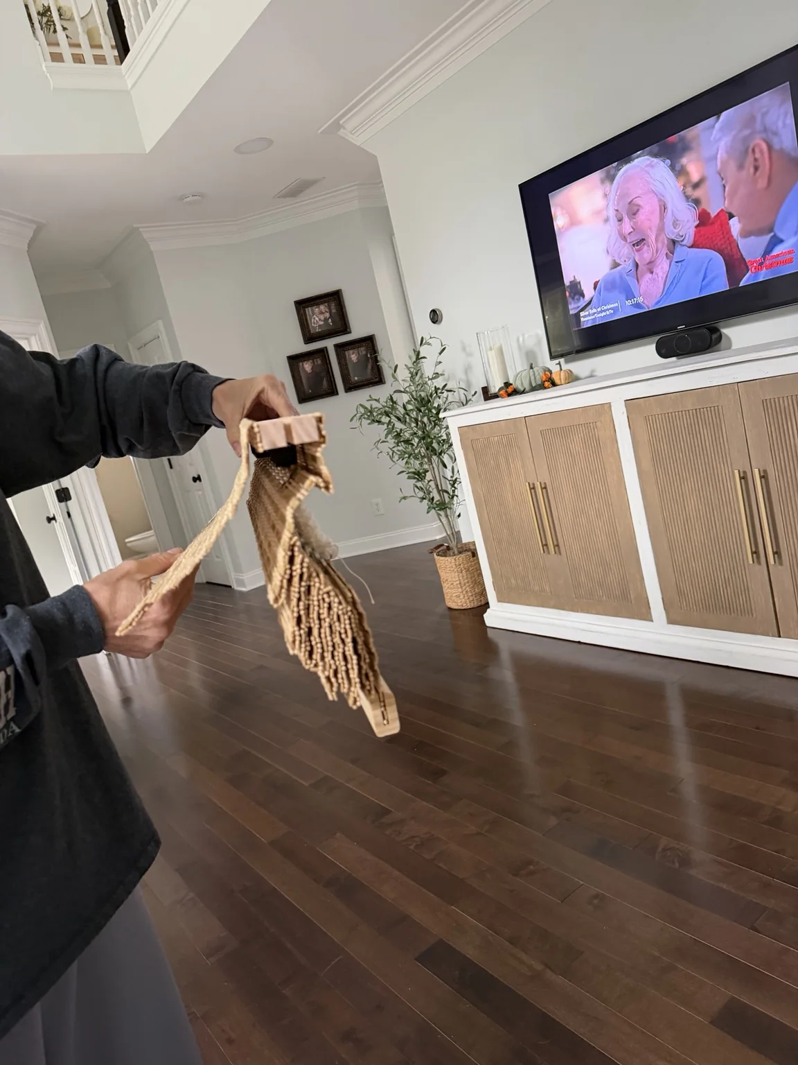 Cordless bamboo Roman shade folded up beneath its wooden header
