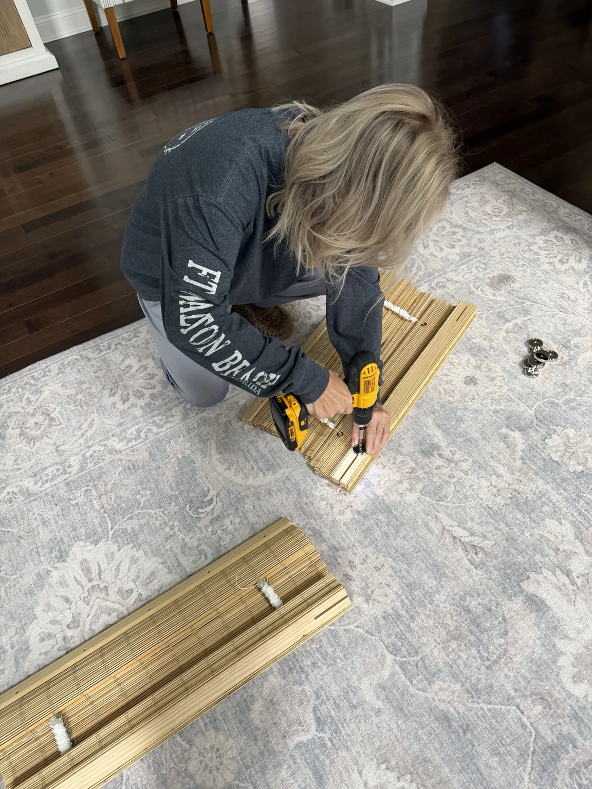 Attaching a magnet to the bamboo shade wooden header with a cordless drill