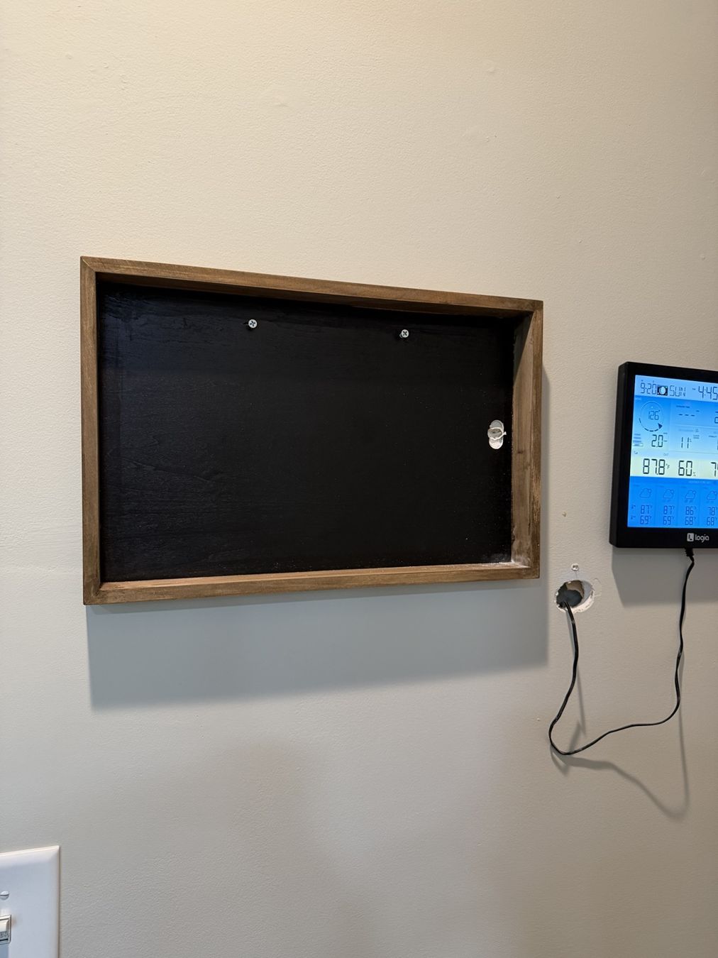 One frame mounted on the wall before the digital calendar is attached.