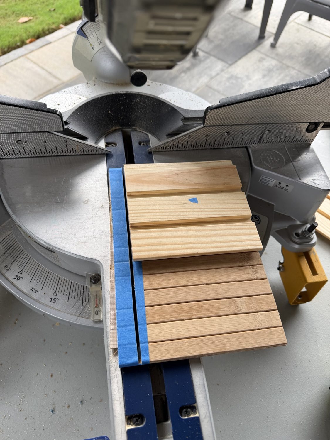 Lining up the shiplap boards for cutting; painter’s tape helps hold the pieces together.